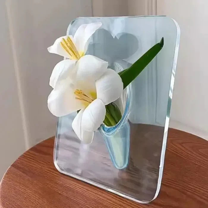Acrylic Frame Vase in clear acrylic featuring a minimalist design with two white flowers and a green leaf, creating a modern home interior decor piece with floating floral effect.