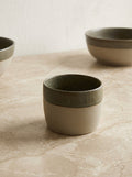 Set of ceramic bowls on a textured surface with a neutral background