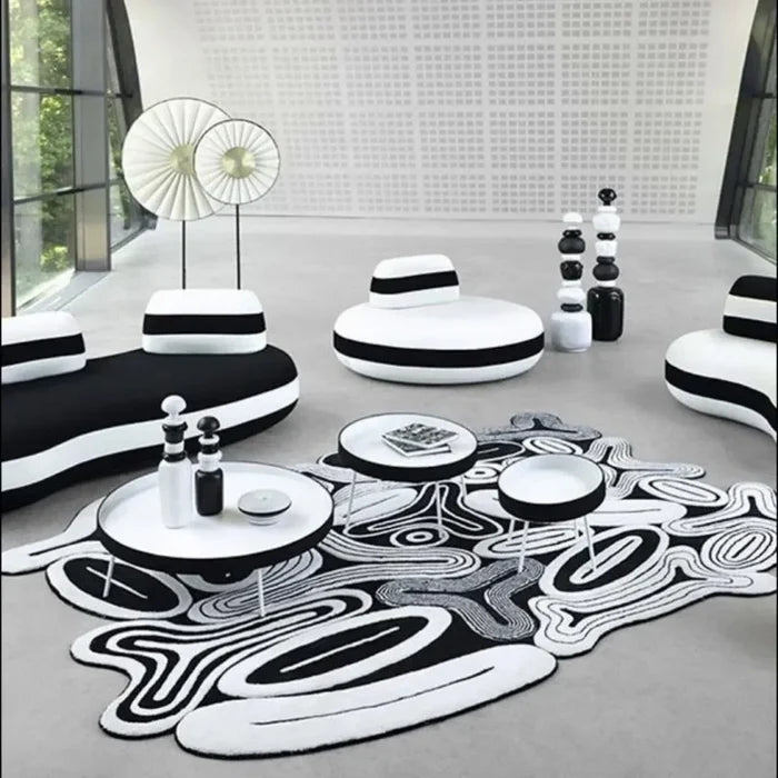 Modern living room with black and white furniture and decor.