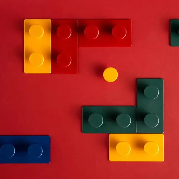 Block Key Hook in vibrant yellow, red, green, and blue colors arranged on a red background, resembling playful building blocks for stylish and functional home decor.