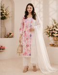 A woman models a three-piece traditional South Asian salwar kameez set. The set features a light pink embroidered kameez kurta with floral patterns, matching white trousers, and a sheer white dupatta.