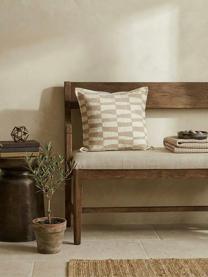 Caramel pattern cushion cover 50x50 cm with neutral checkered design on a wooden bench, styled with earthy decor and soft beige tones