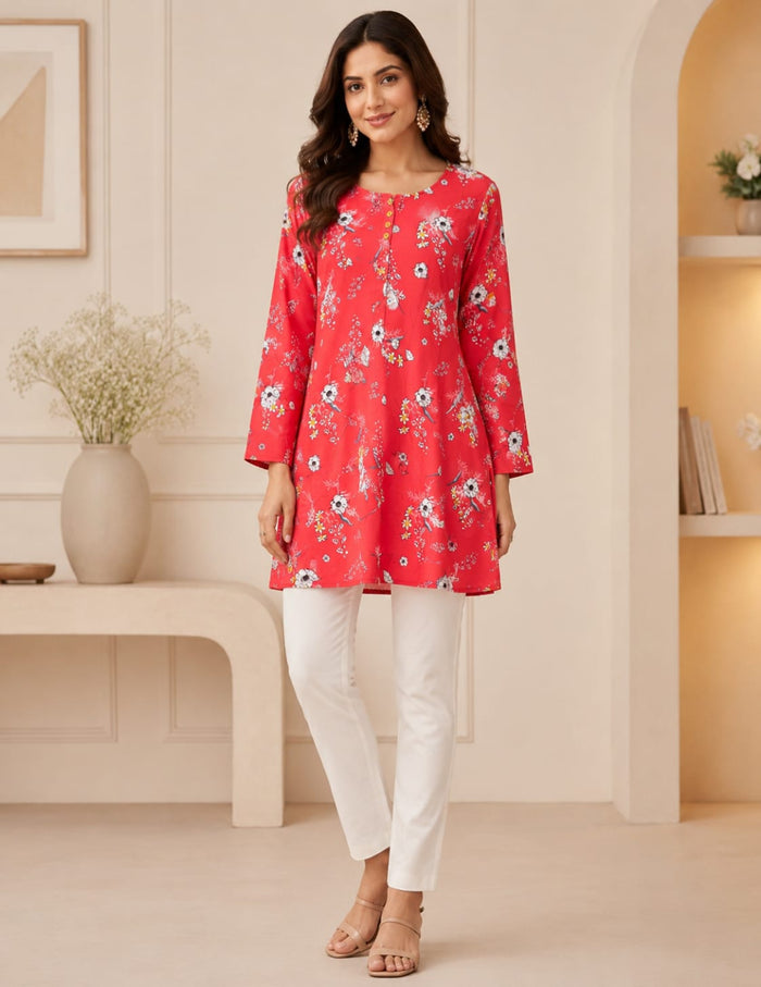 Coral pink floral printed tunic paired with white straight pants for women featuring a relaxed fit and elegant everyday style.