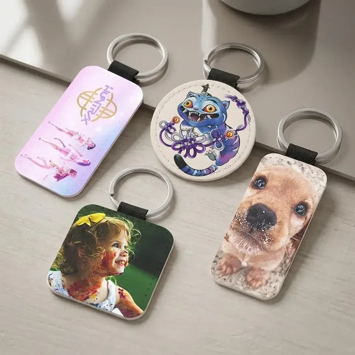 Four keychains with different designs on a light surface