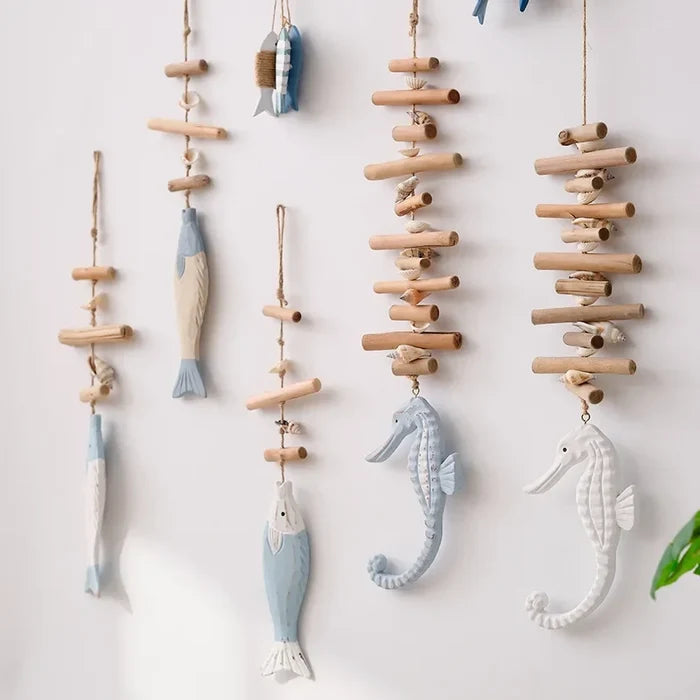 Decorative hanging mobile with fish and seahorse shapes on a white background
