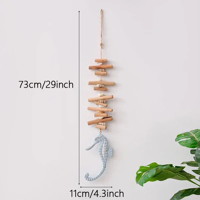 Decorative hanging with seahorse and wooden sticks, shown with measurements against a white background.