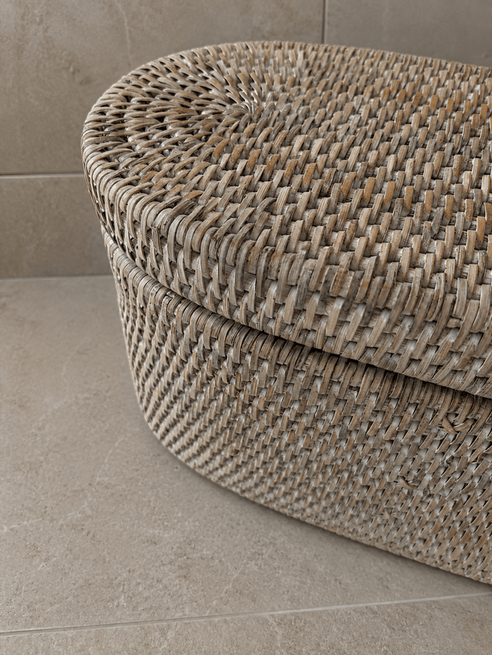 Jarra rattan lidded basket on a tiled floor