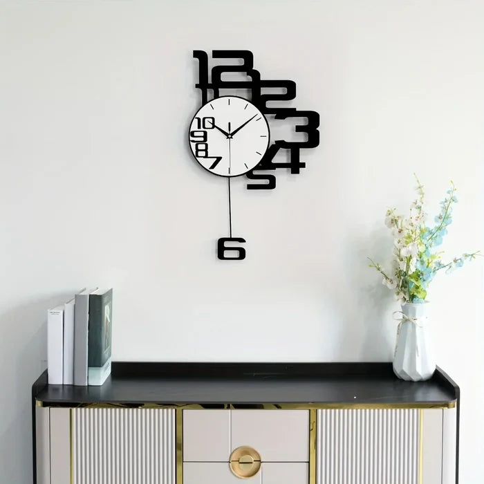 Modern wall clock with bold black numbers, styled above a sleek console table with books and flowers.