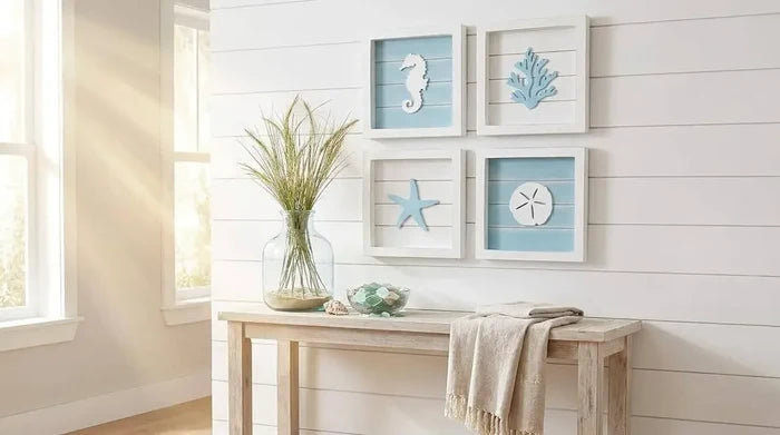 Nautical-themed wall art with seahorse, starfish, and coral decorations on a white wall.