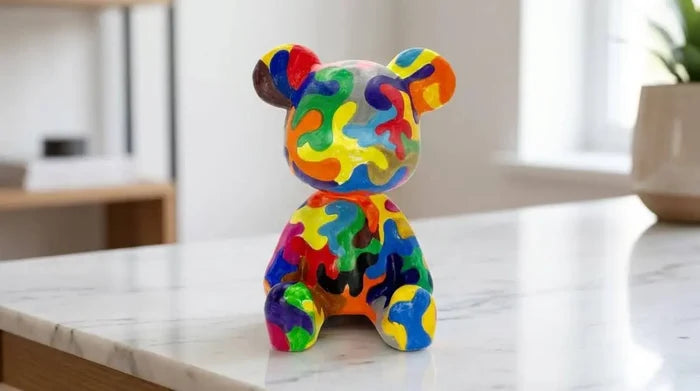 Colorful handcrafted bear figurine for home décor on marble countertop