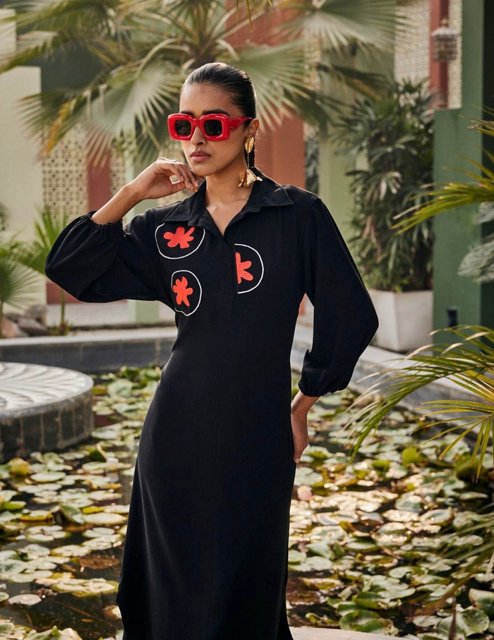 Radiant Noir Black Dress featuring bold floral embroidery, a relaxed silhouette, and elegant detailing for a contemporary and sophisticated statement look.