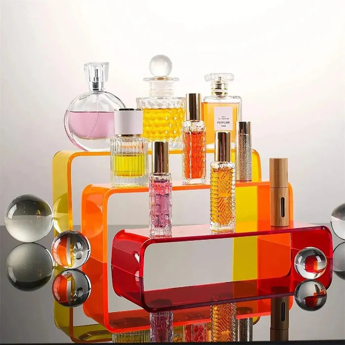 Colorful acrylic perfume organizer with glass bottles and decorative spheres