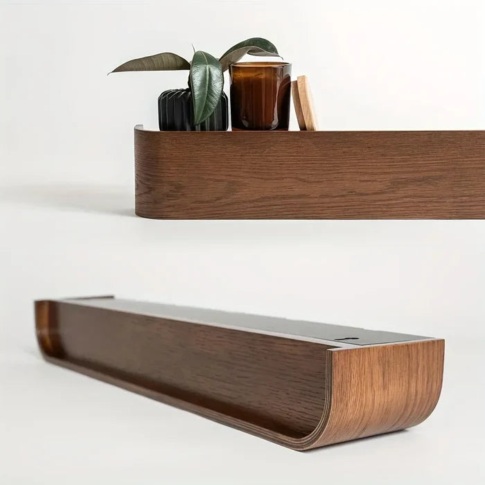 Wooden shelf with decorative items on a white background